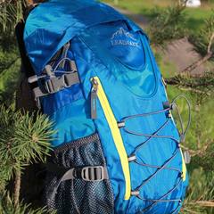 Hiking backpack hanging on a tree branch