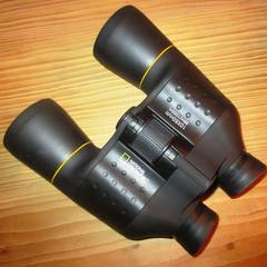 Pair of binoculars on a wood table