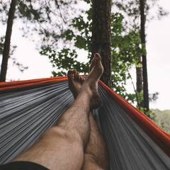 Feet relaxing in a camping hammock