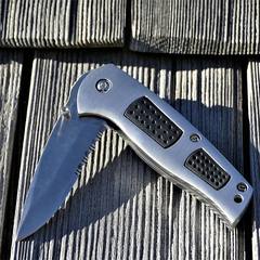 Folding pocket knife on a wood deck