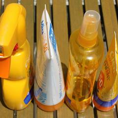 Bottles of sunscreen lined up on a table