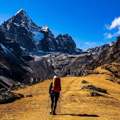 Backpacker on a mountain trail with a full pack